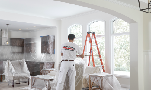 Bright painted interior with professional painter working